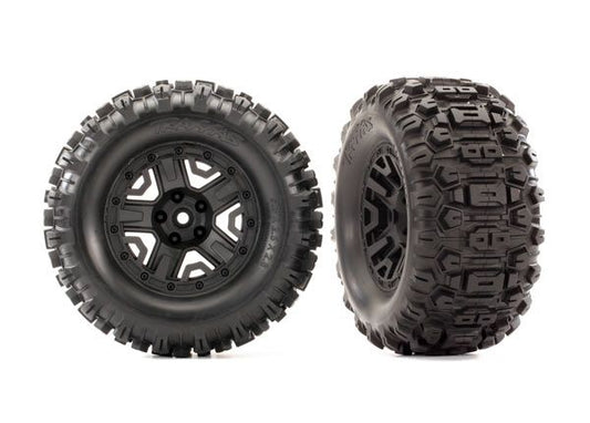 TRA6792 Traxxas Tires &amp; wheels, assembled, glued (2.8") (Rustler 4X4 black wheels, Sledgehammer tires, foam inserts) (2) (TSM rated)